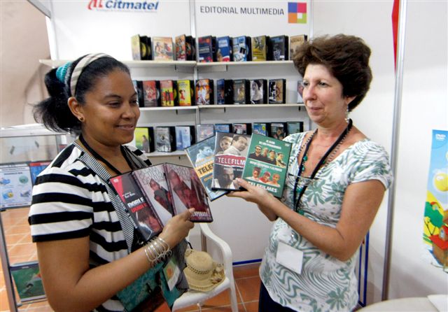  Marlene Oliva (derecha) y Ana Eugenia González, especialistas del departamento comercial de Citmatel, muestranobras del catálogo.